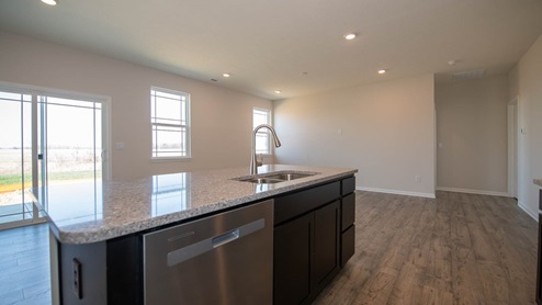 Kitchen with island seating, stainless appliances, plenty of countertop space and storage