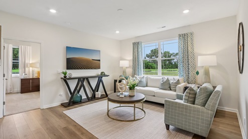 great room with white walls and area rug