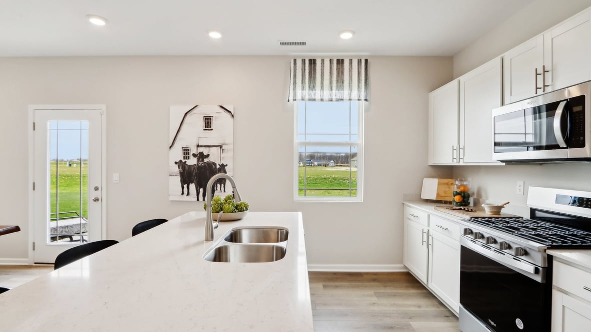 Bright white cabinets and clean kitchen with quartz countertops