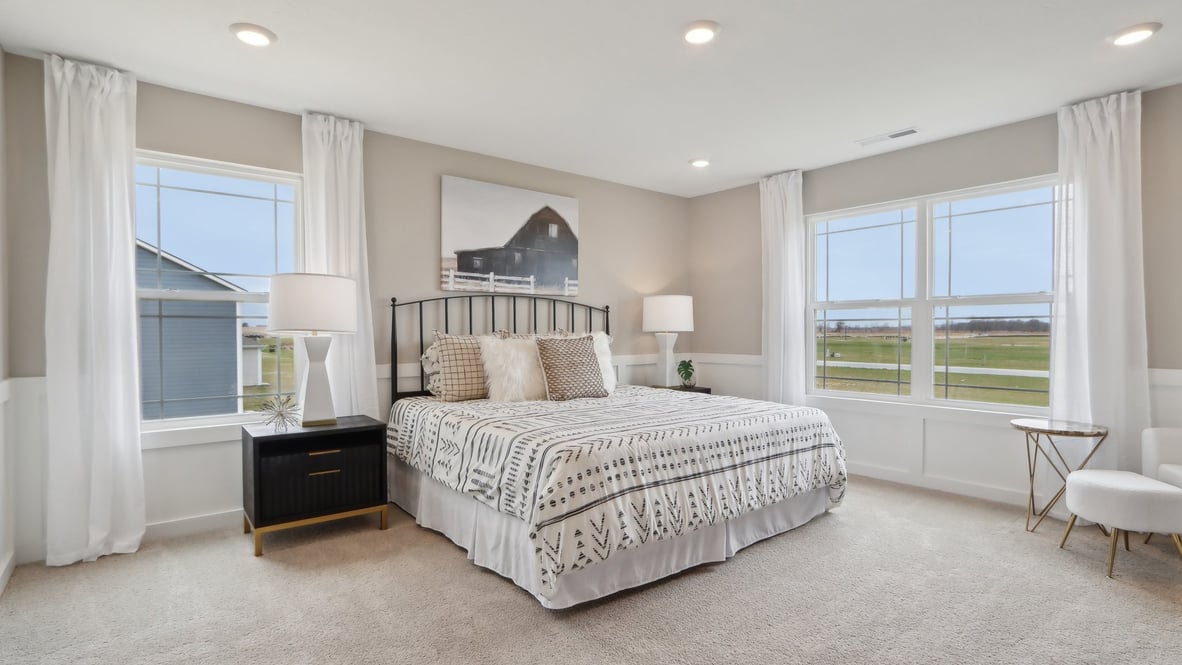 Spacious primary bedroom with natural light