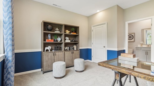 Room with natural light and simple furnishings.