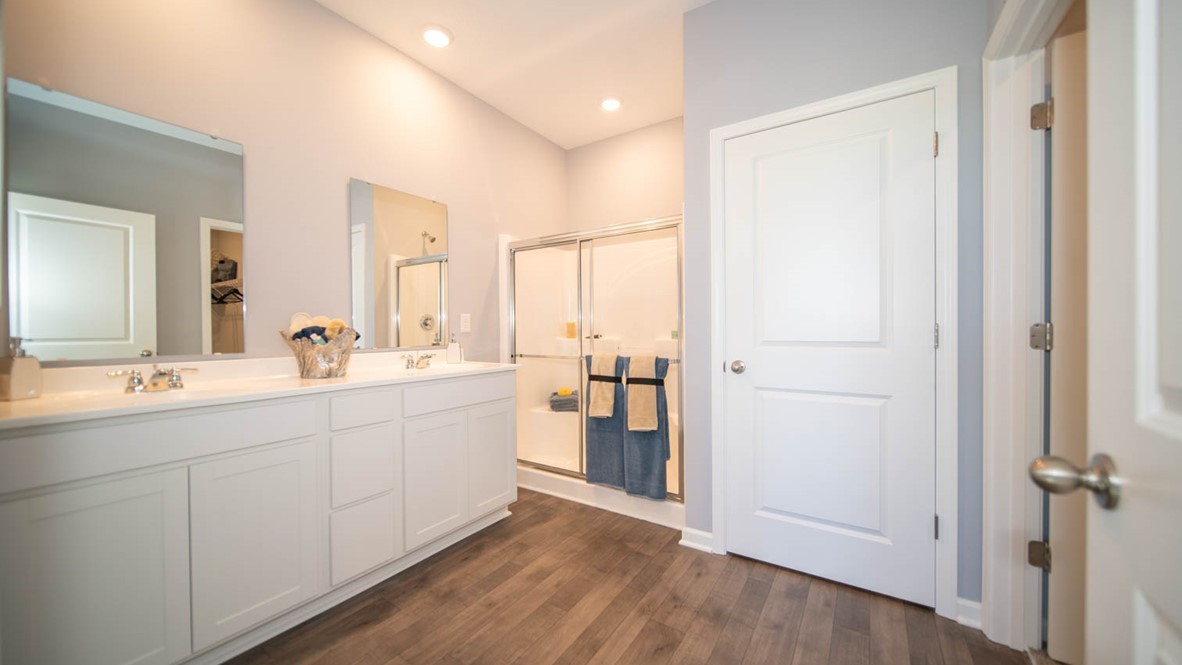 primary bathroom with dual vanity and walk-in shower