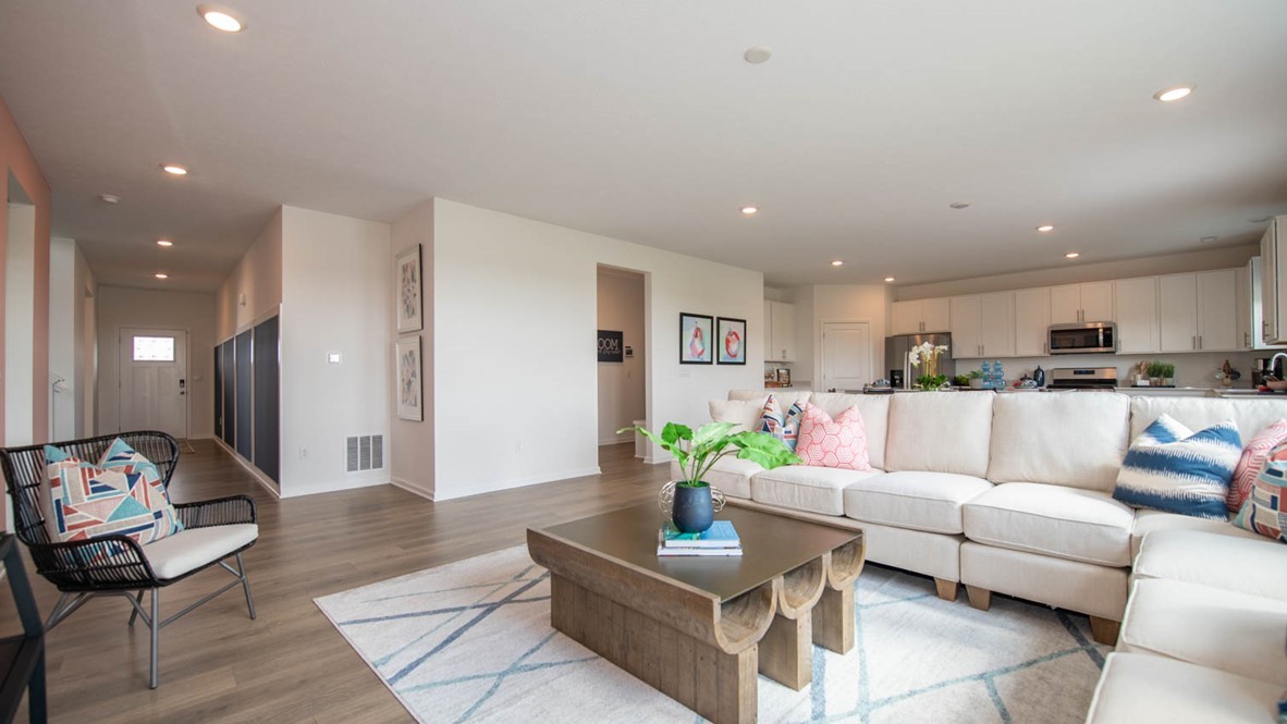 great room with area rug and coffee table, light sectional