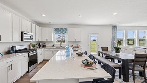 Interior kitchen with center island and white cabinets