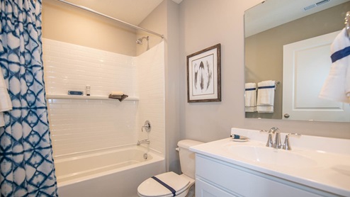 The hall bath includes a tub shower and dual sinks