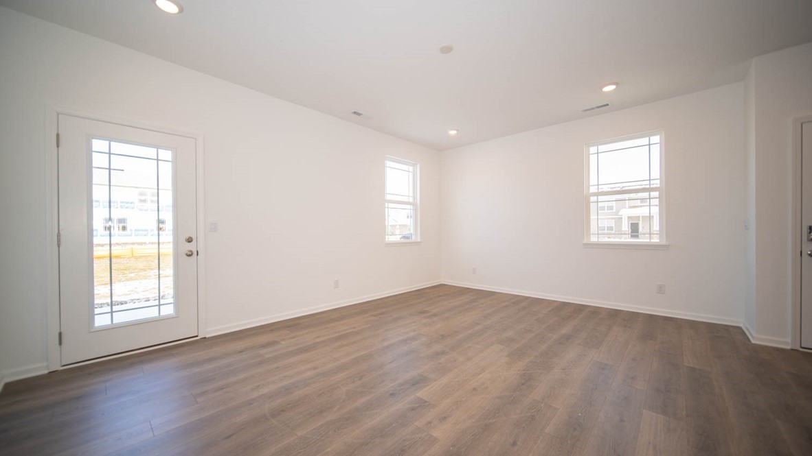 Great room area with a windowed side door to exterior.