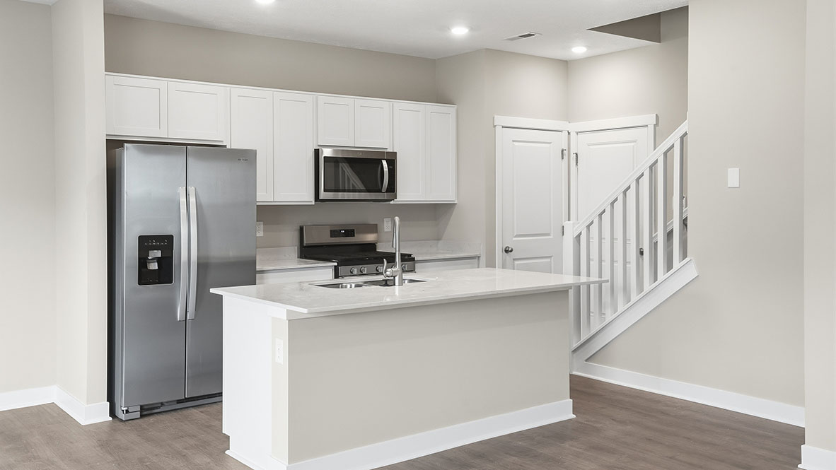 Kitchen with staircase and garage door access