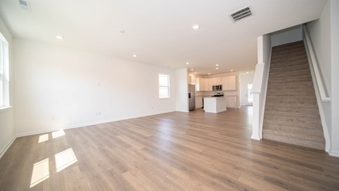 Open-concept living area with stairs to the second floor.