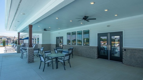 Amenity center pool patio with tables and seating.