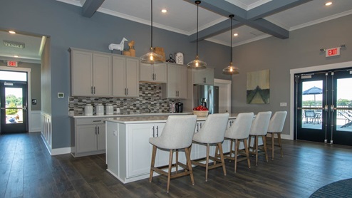 Kitchen area located inside the amenity center with a large island with seating.