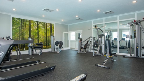 Fitness center with treadmills and weight equipment.