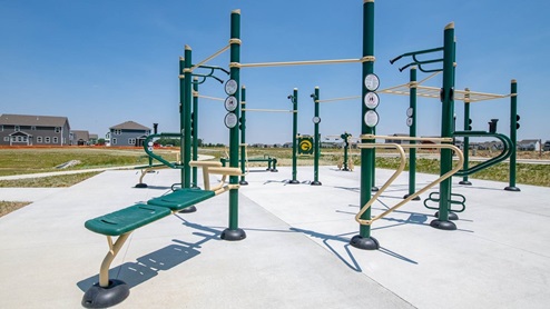 Outdoor fitness center on cement slab.