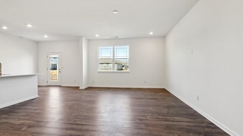 Open-concept living area with a double pane window.
