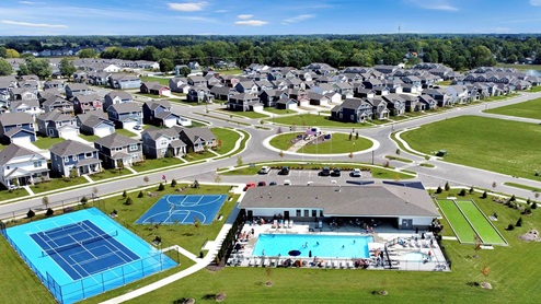 Ariel image of the amenity center that includes an outdoor pool, pickleball court, basketball court, and bocce ball.