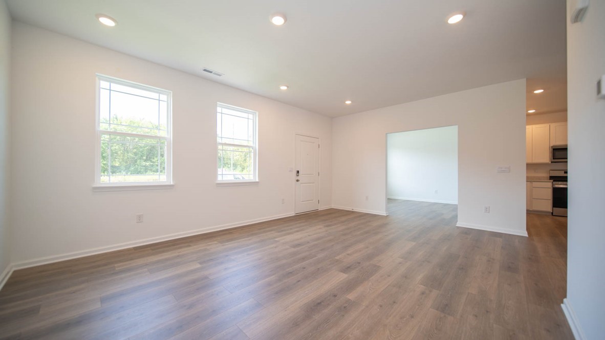 Great room with two windows, laminate flooring, adjacent o the flex room and right off the front door.