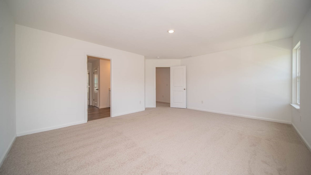 Primary bedroom with access to the primary bathroom.