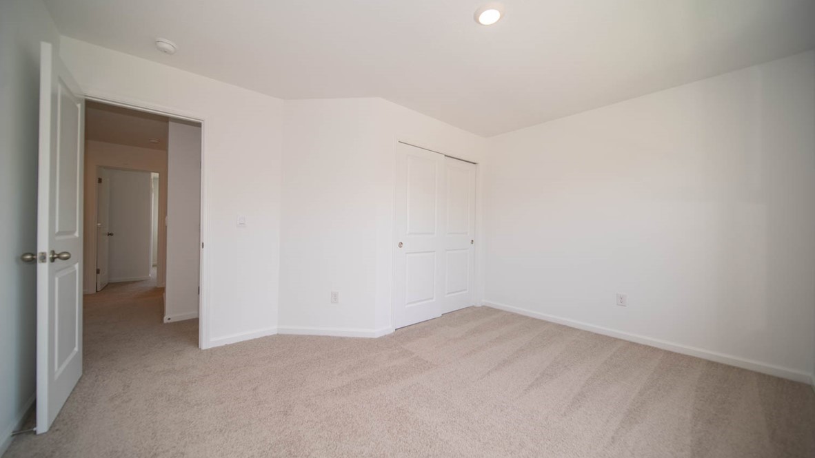Second bedroom with sliding closet doors.