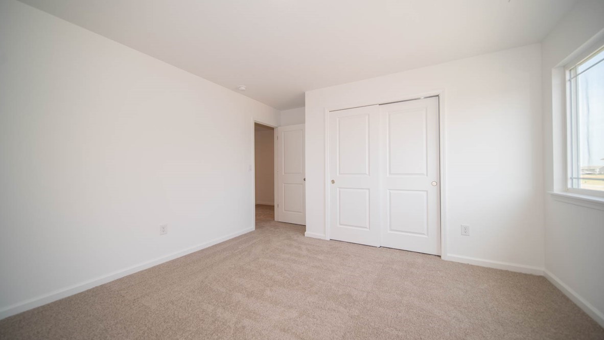 Third bedroom with sliding closet doors.