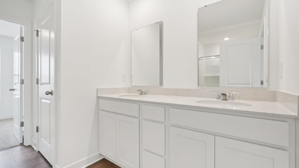 primary bathroom with dual vanity