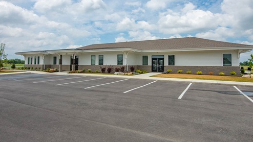 Exterior of the amenity center with available parking spots.