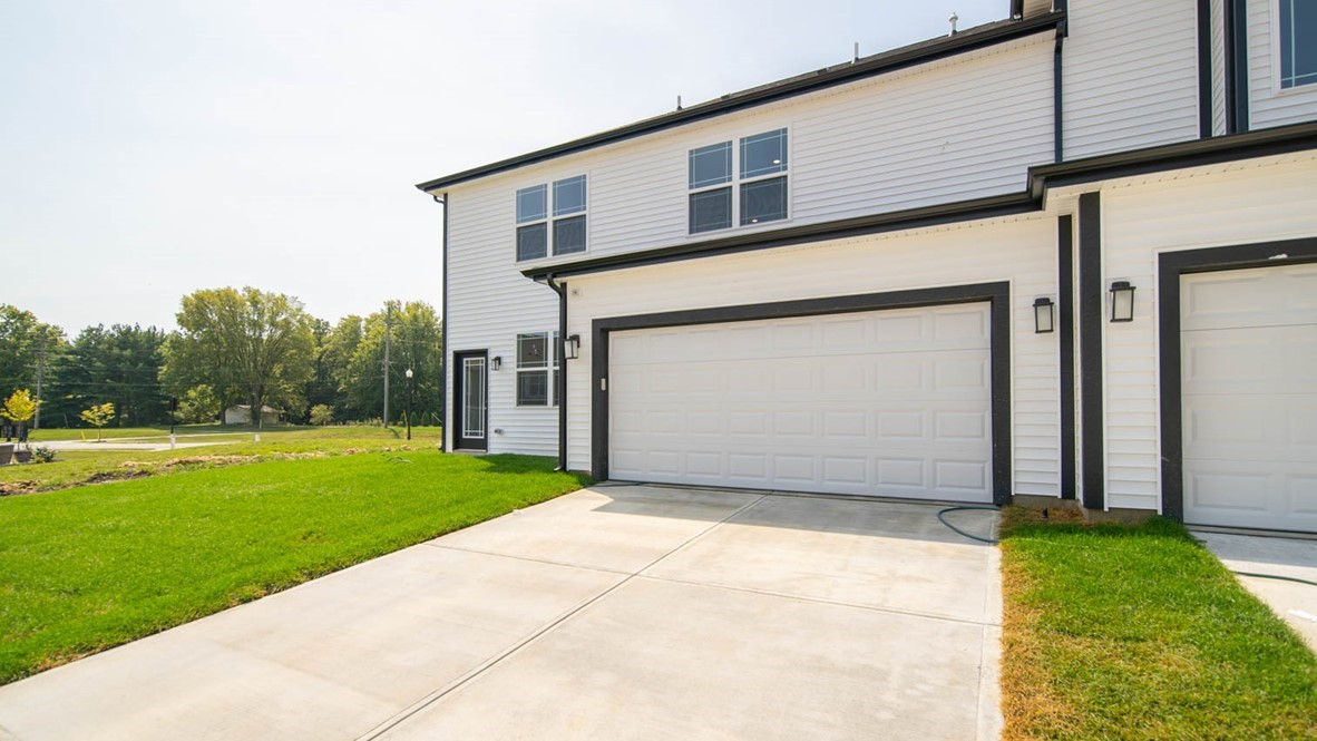 Rear exterior of townhome with a two-car garage.