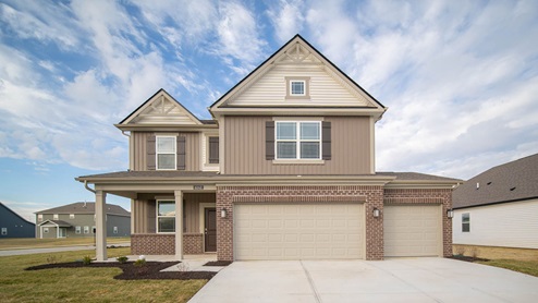 brown scheme two-story exterior with 3 car garage