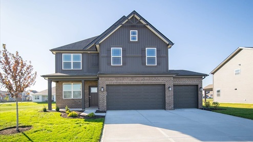 two story home with dark trim and 3 car garage