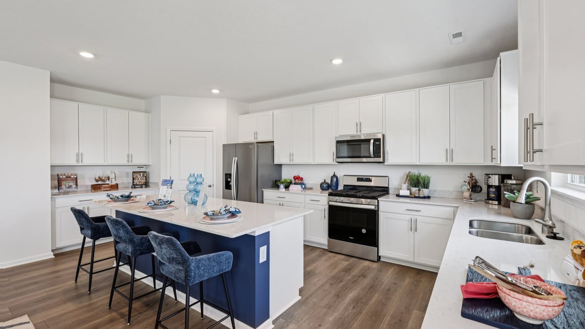 Interior kitchen with center island and white cabinets