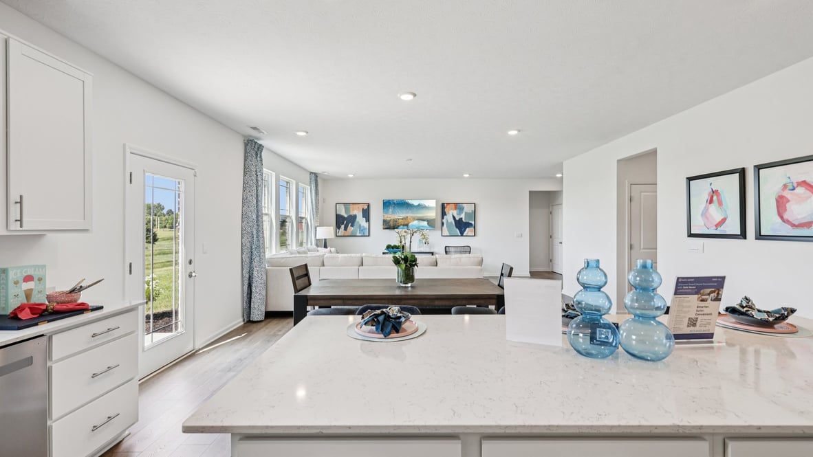 Interior kitchen with center island and white cabinets