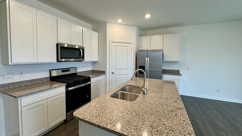 harmony kitchen with white cabinets and alpina quartz countertops