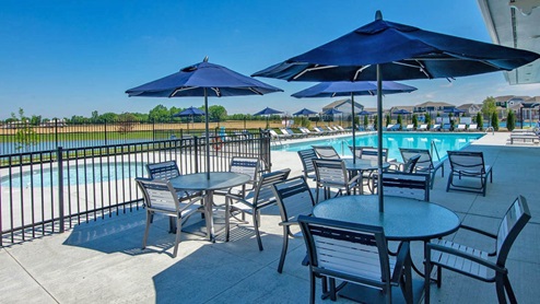 Trailside seating area with tables, chairs and umbrellas