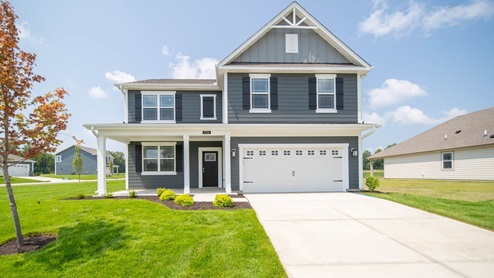 two story home with gray blue color scheme and two car garage