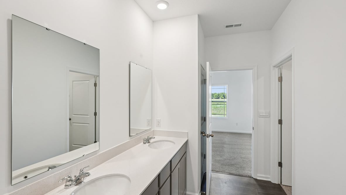 Owner’s ensuite adds dual vanity and walk-in shower view