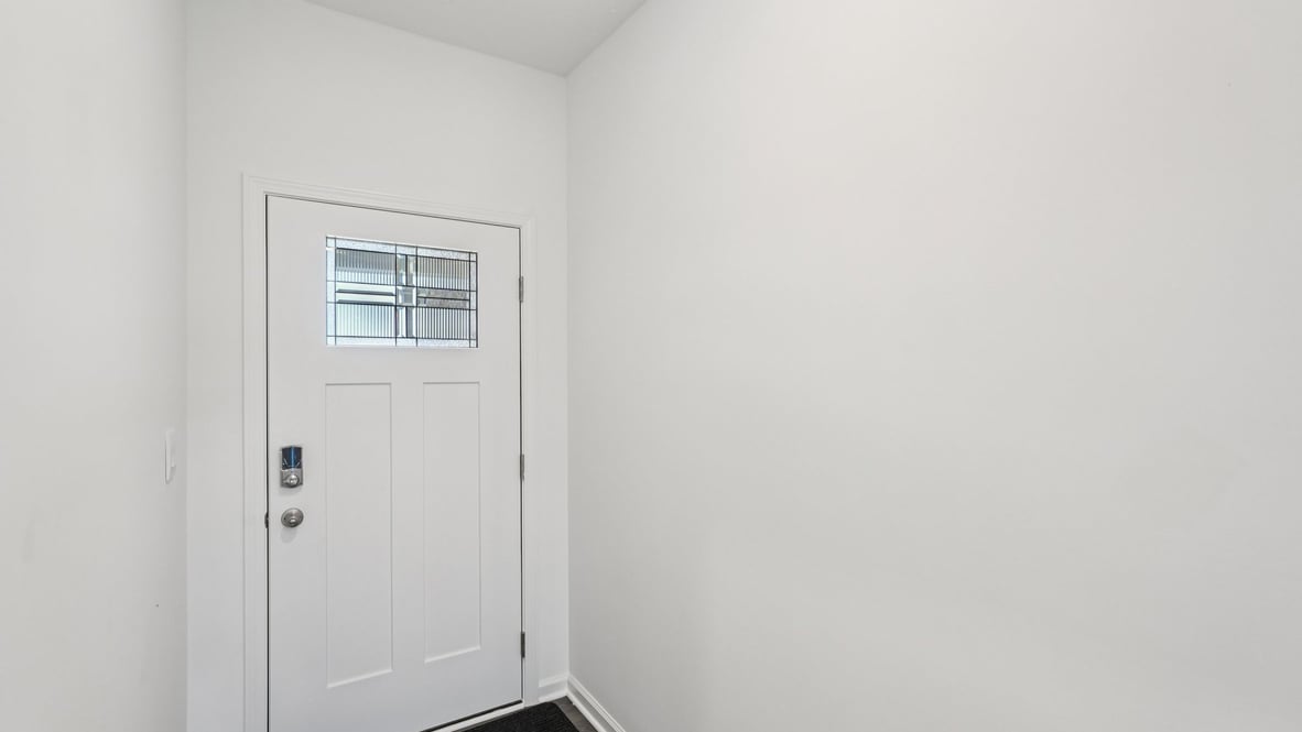 Entry foyer with wood-style tile floors and view into adjacent rooms D.R. Horton's Parkview Village