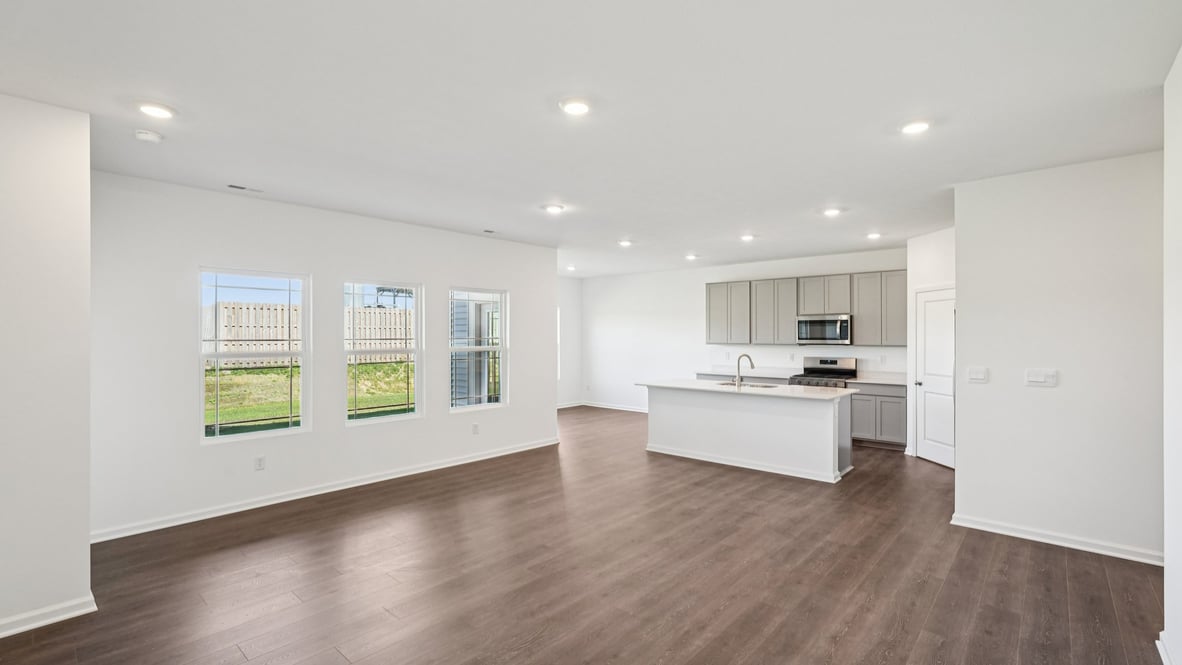 View from the living room into the dining and kitchen areas showcasing open-concept flow