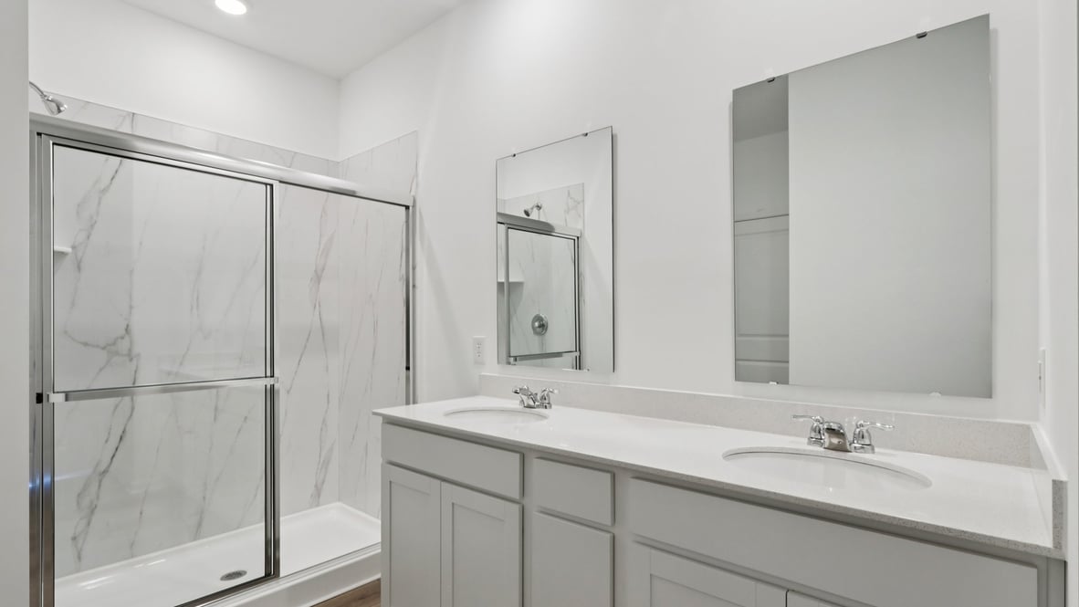 primary bathroom dual sinks and walk in shower