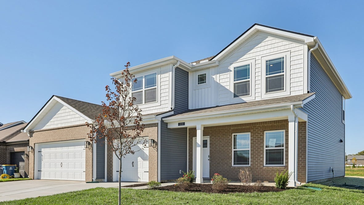 Side exterior view of the Johnstown with white siding and brown brick