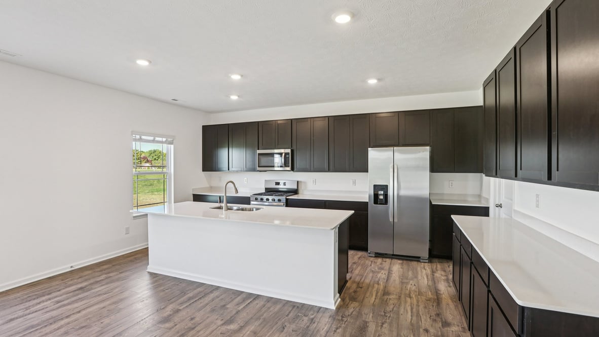 kitchen with stained cabinets island and quartz counters