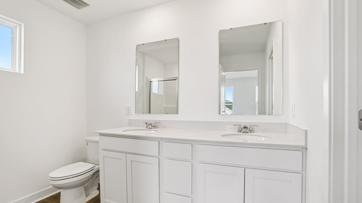 primary bathroom with dual vanity