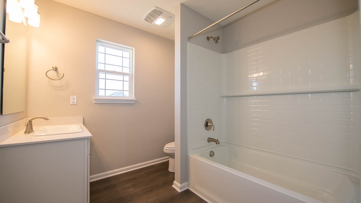 bathroom with shower and tub