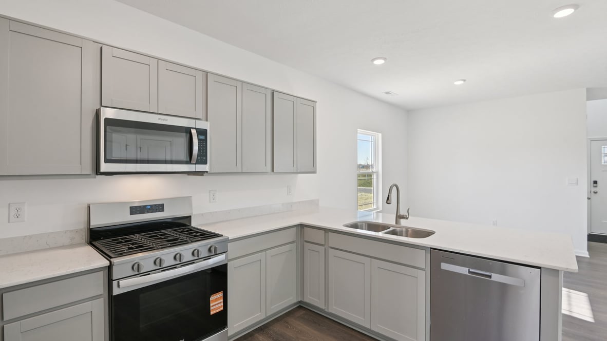 full kitchen with quartz countertops and stainless steel appliances