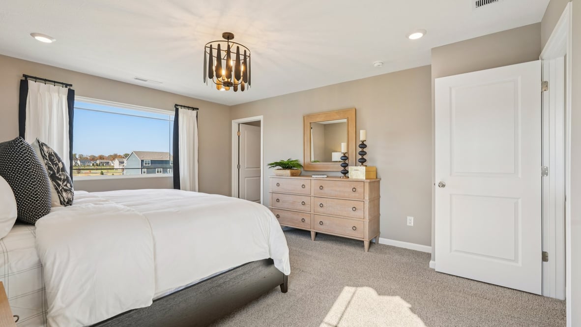 primary bedroom has multiple windows