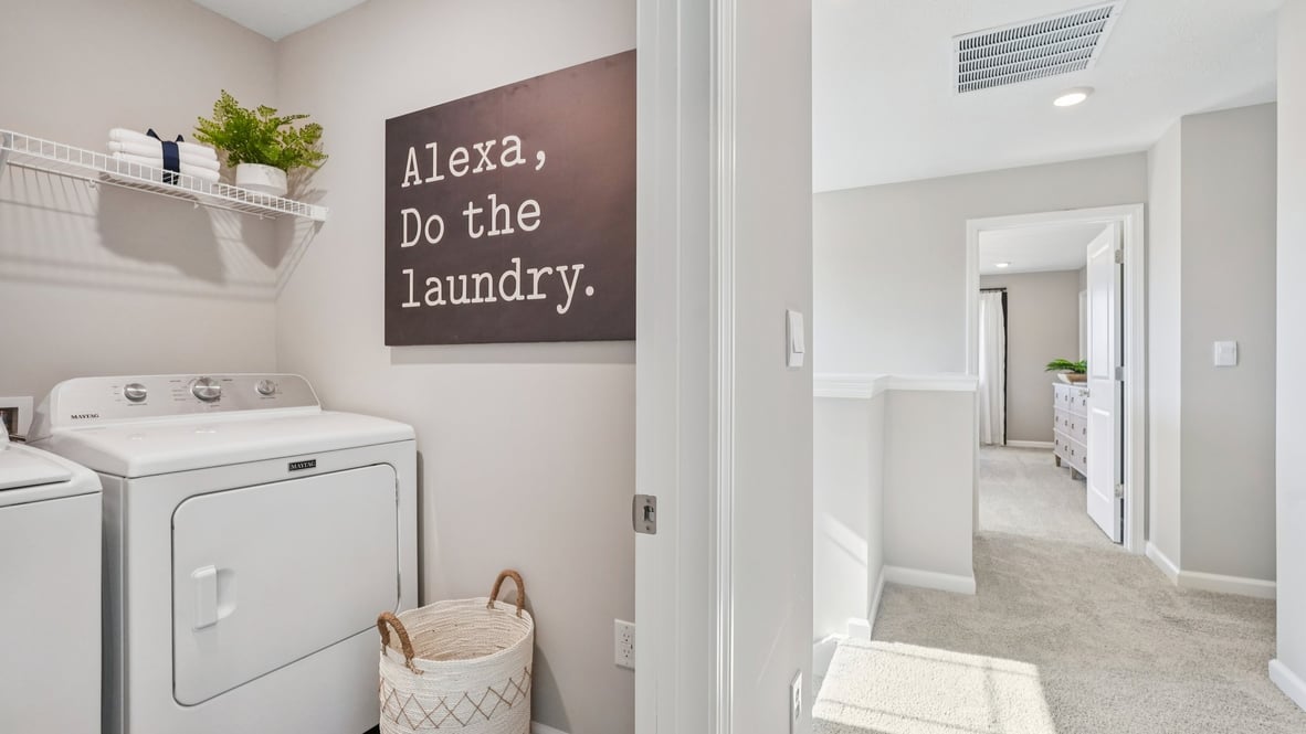 upper level laundry room with shelving
