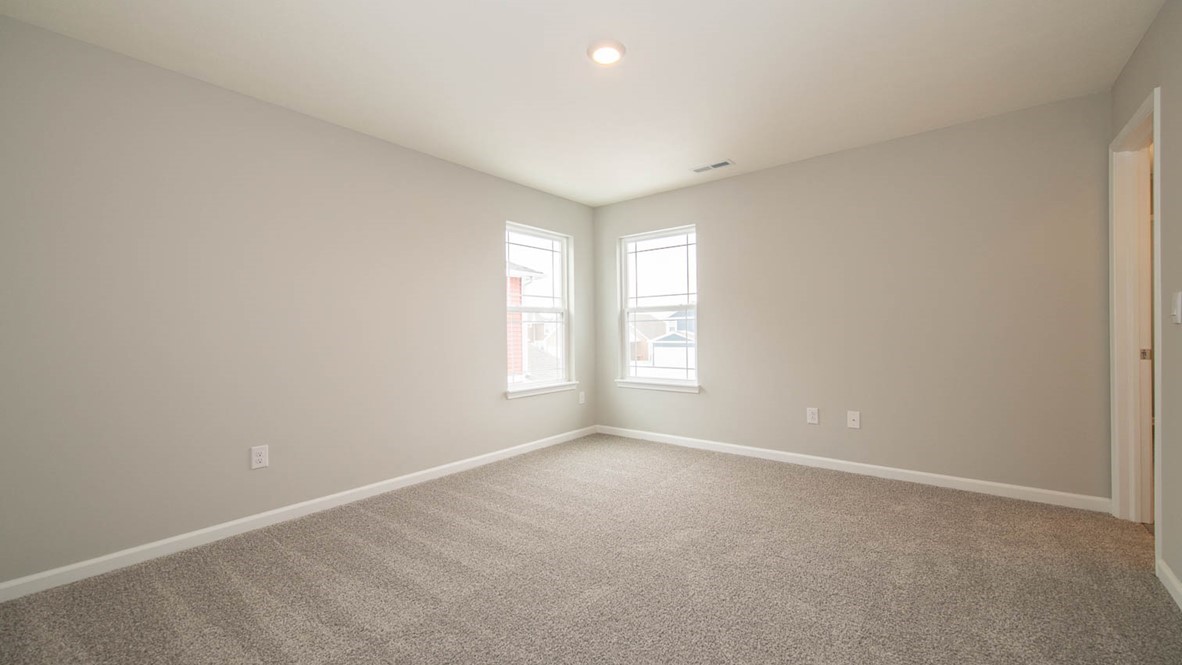 primary bedroom with windows