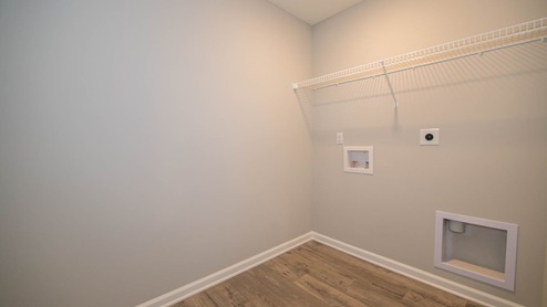 upper level laundry room with shelving