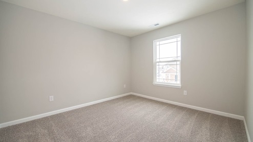bedroom 3 with window overlooking side yard