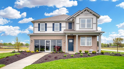 two-story model home with walkway to sales office in lieu of garage door