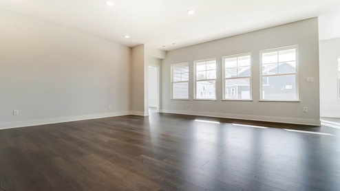 Fairfax great room with abundant natural light and laminate flooring