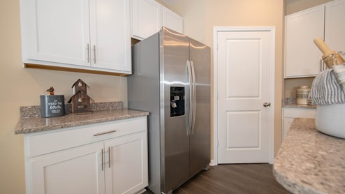 The kitchen includes stainless appliances