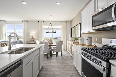 henley kitchen with white cabinets and stainless steel appliances